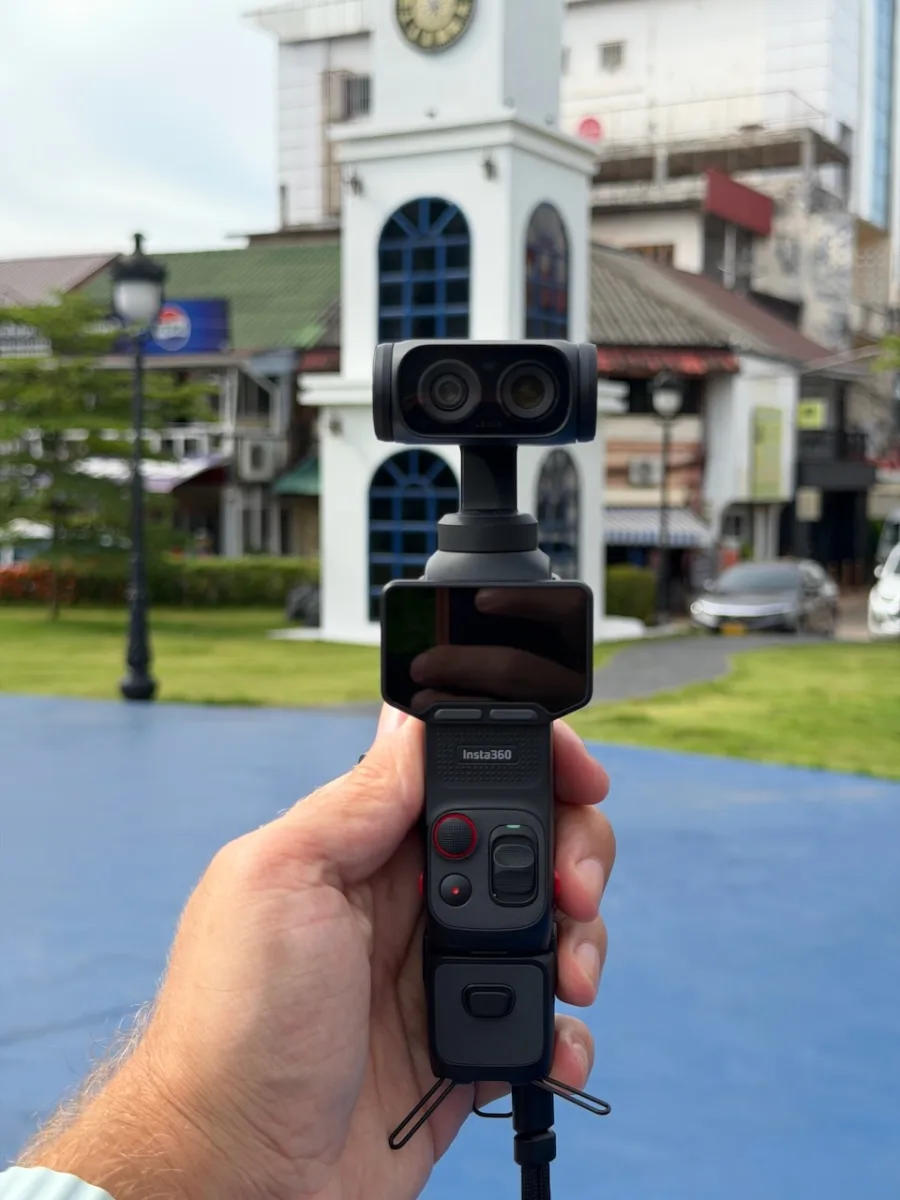 Insta360 Luna Ultra in der Hand gehalten, im Hintergrund ein heller Kirchturm